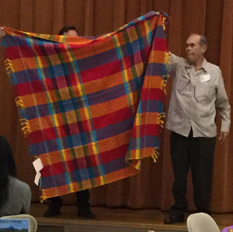 Frank Snell Holding Table Cloth from the Live Auction