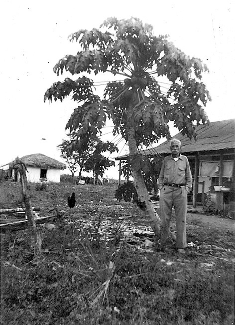 WW Snell in his backyard with papaya tree